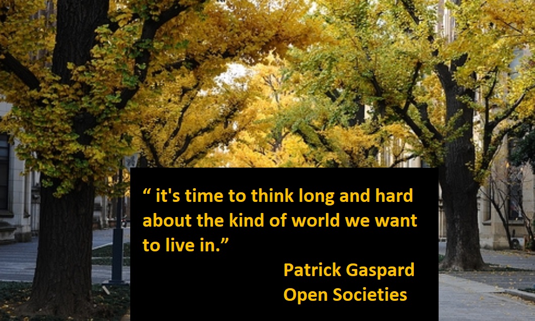 It's time to think long and hard about the kind of world we want to live in.  Patrick Gaspard, Open Societies - background of city street with trees