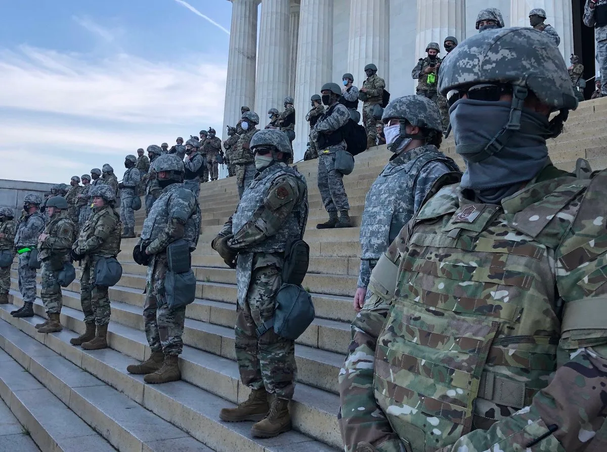 about 35 members of the National Guard standing on steps of Lincoln Memorial