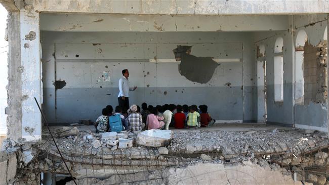 bare classroom in Yemen, damaged by missiles, with students and teacher