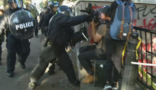police in Washington DC strike a seated Australian reproter June 1 2020