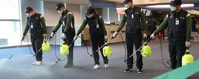 airport staff spray disinfectant in Seoul airport