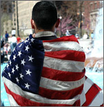 person with flag draped over shoulders